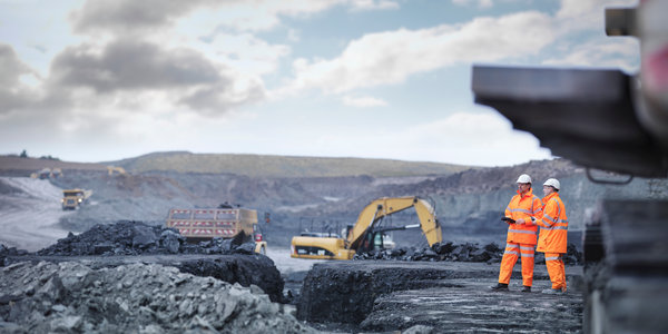 Miners in discussion in surface coal mine